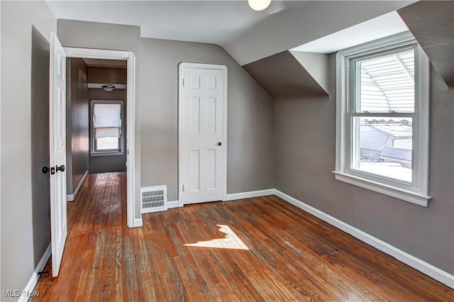 bonus room featuring vaulted ceiling and dark hardwood / wood-style floors