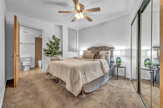 carpeted bedroom with ceiling fan and ensuite bathroom