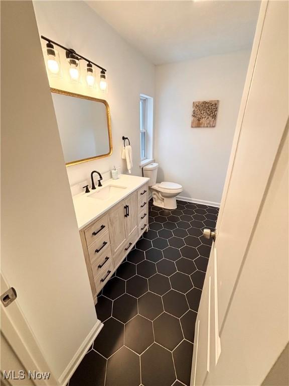 bathroom with vanity and toilet