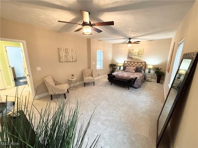 bedroom featuring ceiling fan, carpet flooring, and a textured ceiling