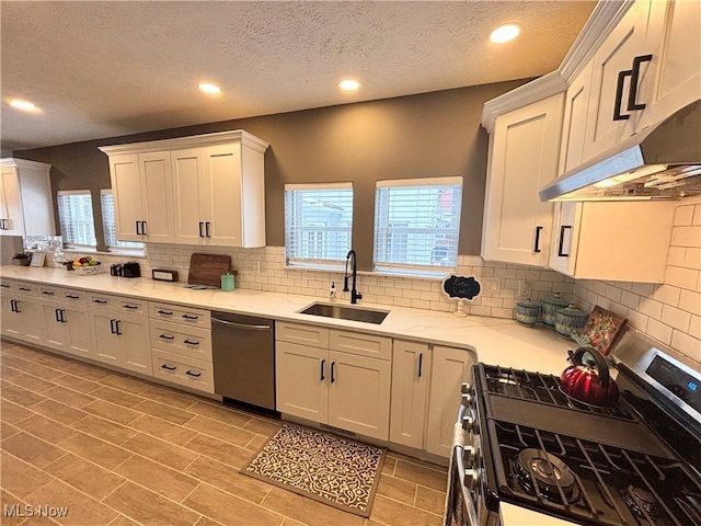 kitchen featuring stainless steel appliances, sink, and white cabinets