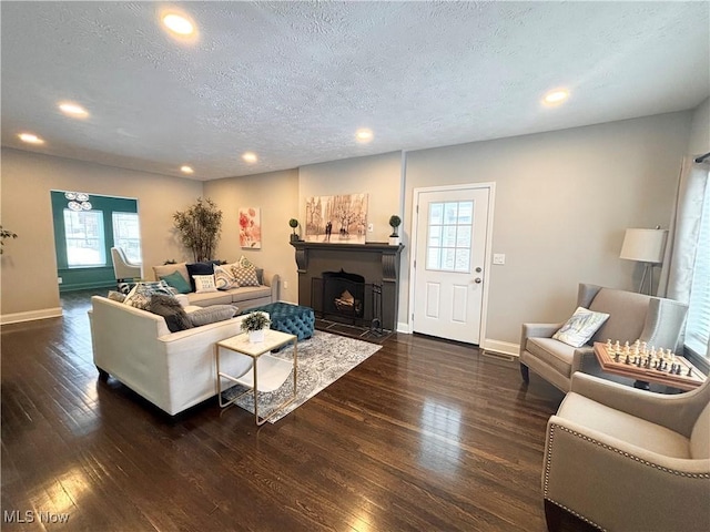 living room featuring dark hardwood / wood-style floors and a textured ceiling