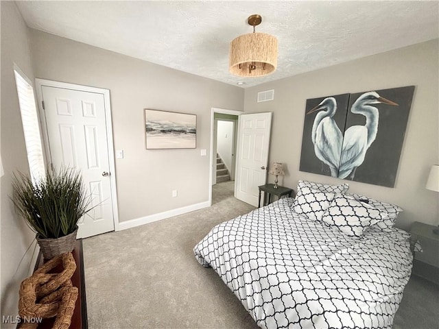 carpeted bedroom with a textured ceiling