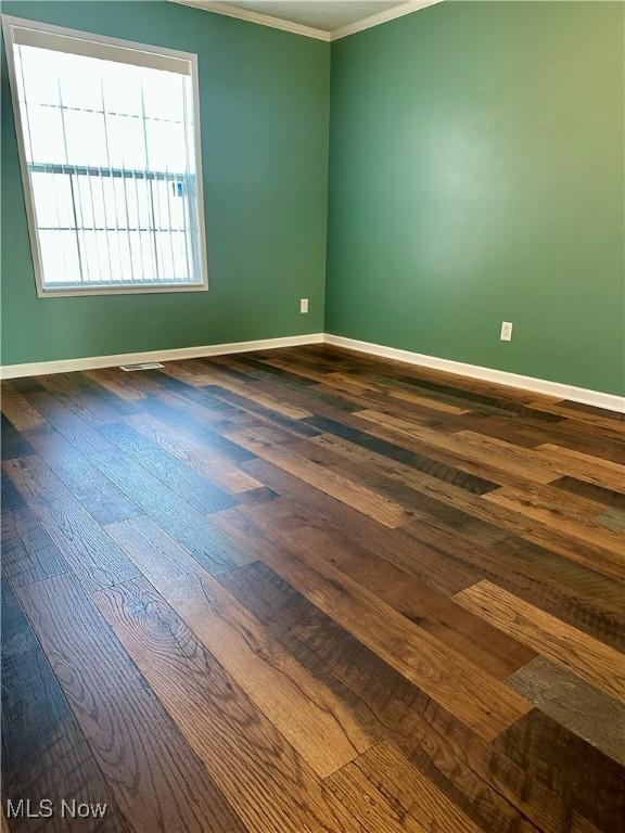 unfurnished room featuring crown molding and hardwood / wood-style floors