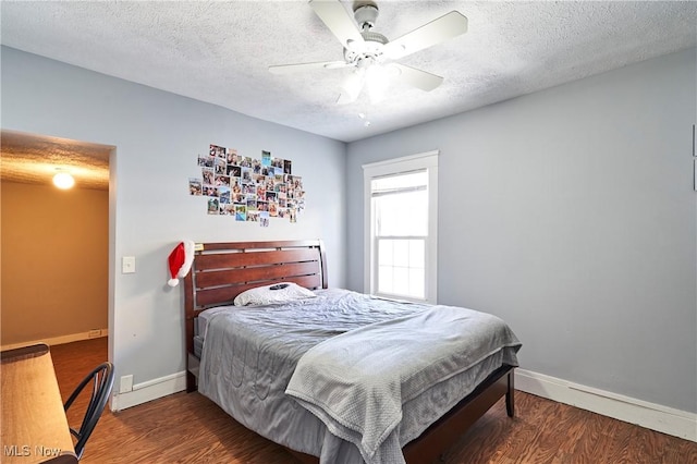 bedroom featuring ceiling fan, a textured ceiling, and dark hardwood / wood-style floors