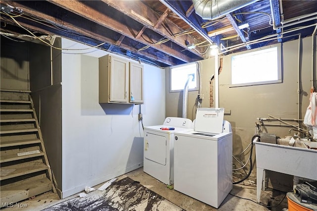 laundry room with cabinets and washing machine and clothes dryer