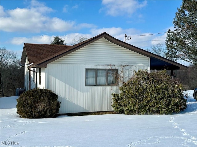 snow covered property featuring cooling unit