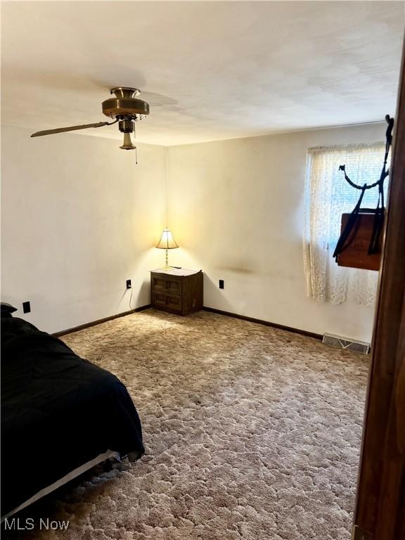 bedroom featuring ceiling fan and carpet