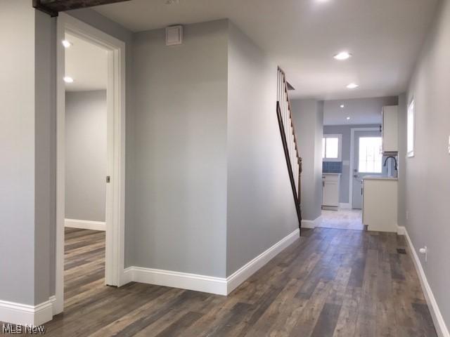 corridor with dark wood-type flooring