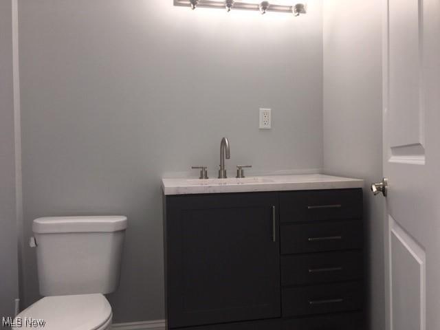 bathroom with toilet and vanity