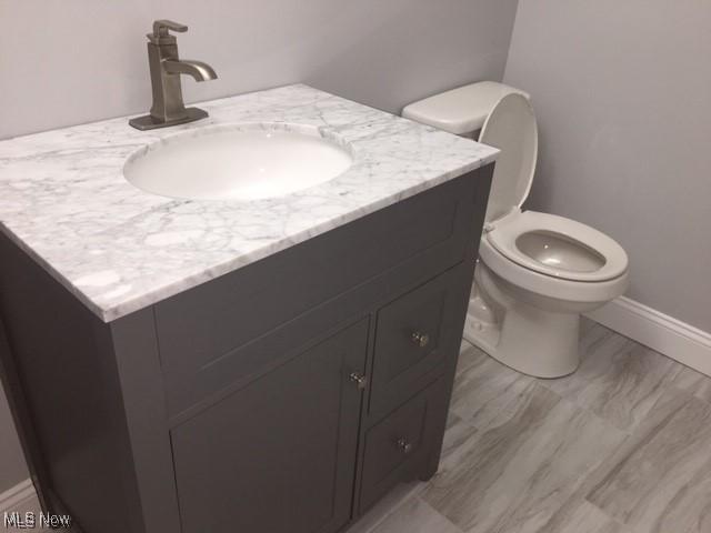 bathroom with toilet and vanity