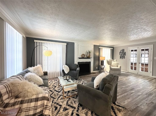 living room with french doors, ornamental molding, a textured ceiling, and hardwood / wood-style flooring