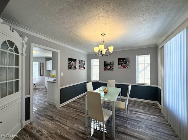 dining room featuring dark wood-type flooring, a chandelier, and a healthy amount of sunlight