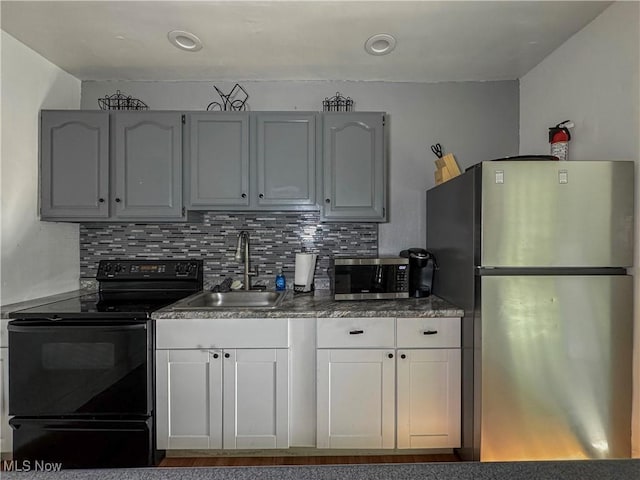 kitchen with decorative backsplash, sink, and appliances with stainless steel finishes