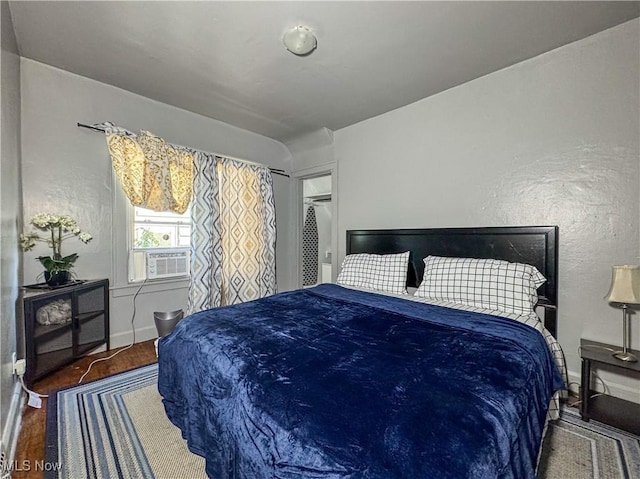 bedroom featuring cooling unit, dark hardwood / wood-style flooring, and a closet