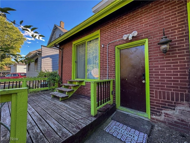 property entrance featuring a wooden deck