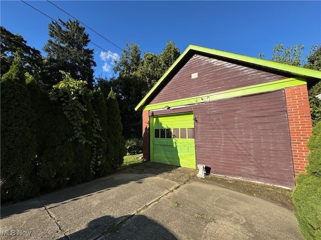 view of side of property with a garage and an outbuilding