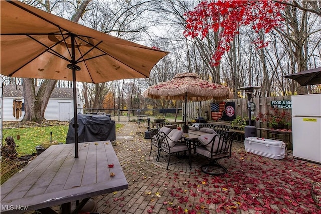 wooden deck with a patio area, area for grilling, and a shed