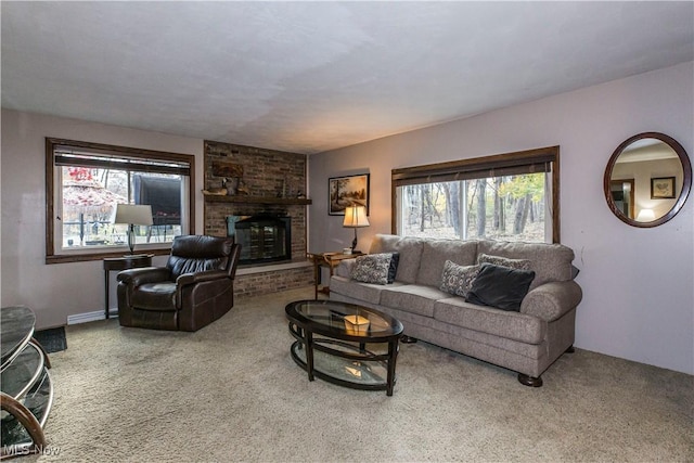 living room with a brick fireplace and carpet floors