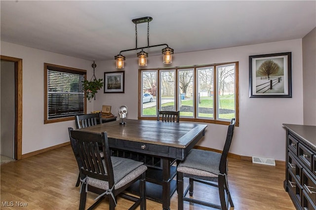 dining space with light hardwood / wood-style flooring