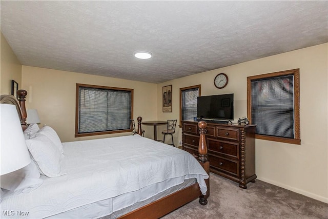 carpeted bedroom featuring a textured ceiling