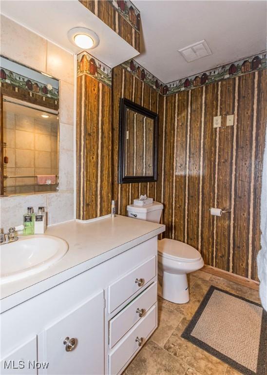 bathroom featuring toilet and vanity