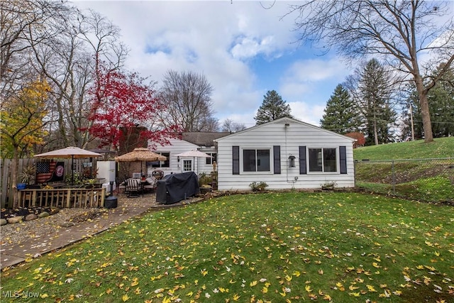 back of house featuring a gazebo and a yard