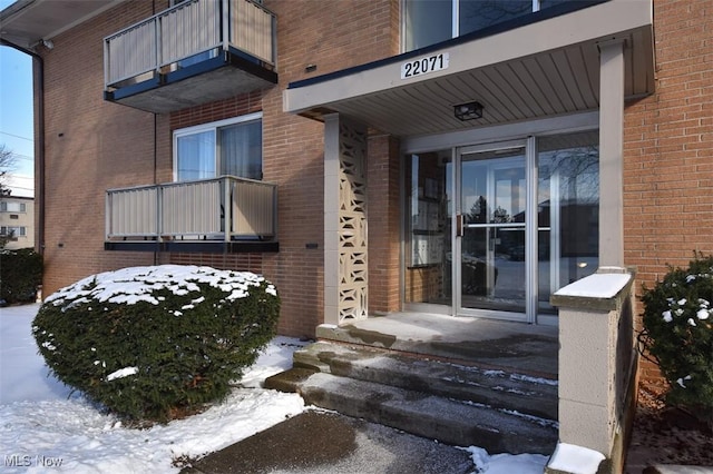 view of snow covered property entrance