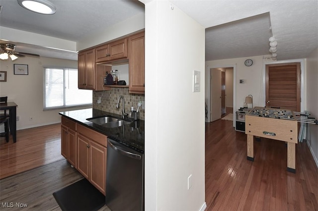 kitchen featuring ceiling fan, tasteful backsplash, dark hardwood / wood-style flooring, dishwasher, and sink