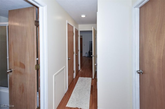 hallway with wood-type flooring