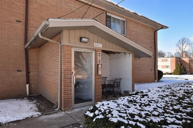 view of snow covered property entrance