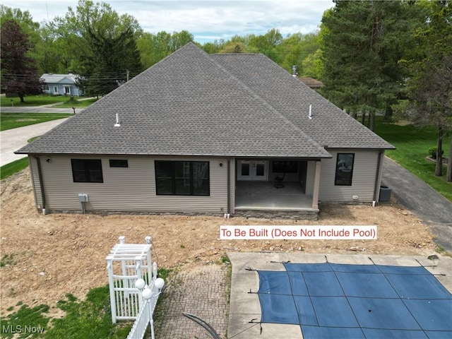 13430 Schreiber Rd, Valley View, OH 44125 - back of property featuring central air condition unit, a shingled roof, a covered pool, and a patio area
