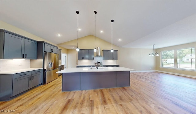 13430 Schreiber Rd, Valley View, OH 44125 - kitchen featuring extractor fan, light wood-type flooring, light countertops, stainless steel fridge with ice dispenser, and vaulted ceiling