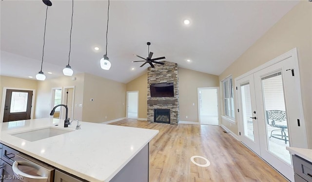 13430 Schreiber Rd, Valley View, OH 44125 - kitchen with ceiling fan, decorative light fixtures, a fireplace, a sink, and light wood-style floors