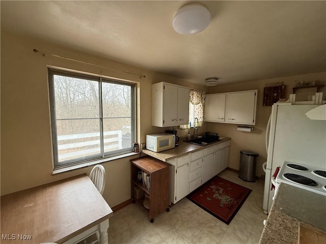 kitchen featuring extractor fan, sink, white cabinets, and white appliances