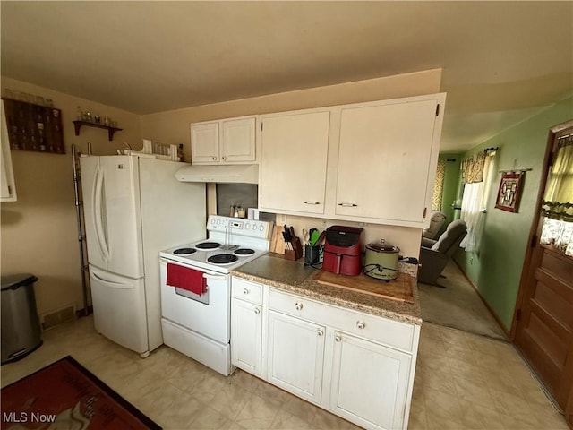 kitchen featuring white cabinetry and white appliances