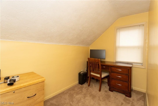 office with vaulted ceiling, a textured ceiling, and light carpet