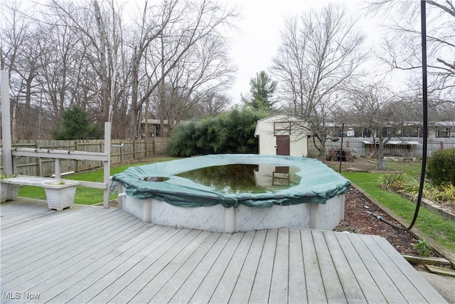 wooden deck with a covered pool and a storage shed