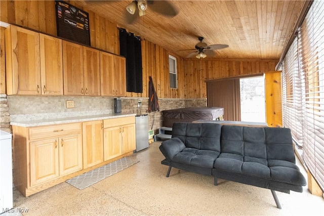 kitchen with ceiling fan, vaulted ceiling, wooden walls, and wooden ceiling