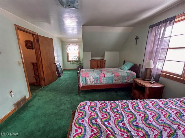 bedroom featuring vaulted ceiling and dark colored carpet