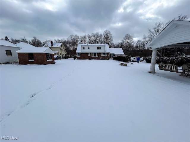 view of yard layered in snow