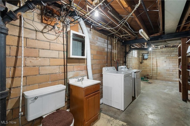 basement featuring washer and dryer and sink