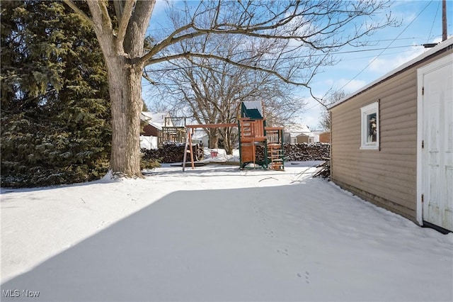 snowy yard with a playground