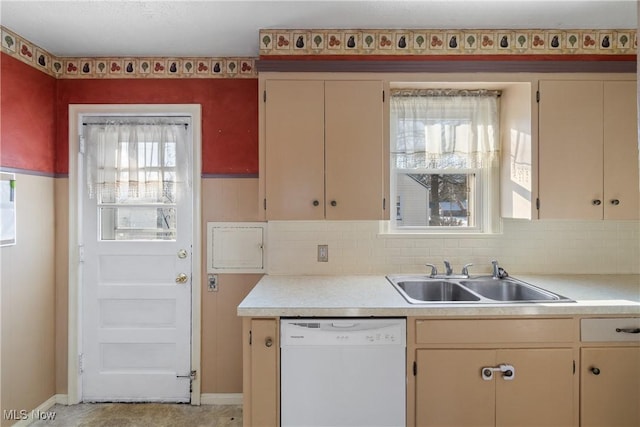 kitchen featuring a healthy amount of sunlight, dishwasher, cream cabinetry, and sink