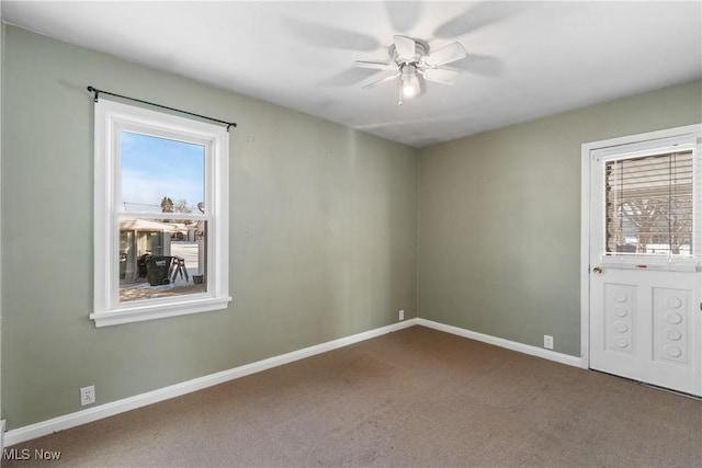 carpeted spare room with ceiling fan