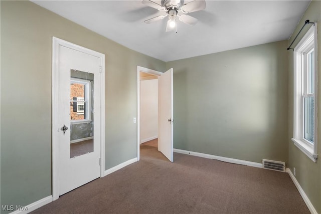 unfurnished bedroom featuring ceiling fan and carpet floors