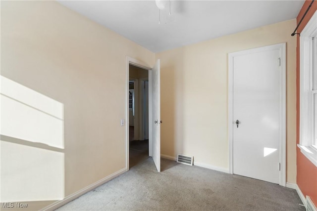 unfurnished bedroom with light colored carpet