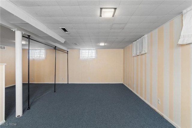 basement with a wealth of natural light and carpet