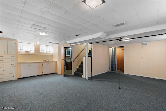 basement featuring dark colored carpet