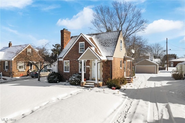 bungalow with a garage and an outbuilding